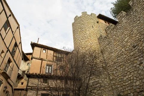 Typical orange-colored adobe and wood facades in the medieval village of Al.. Stock Photos