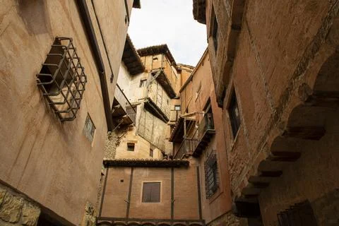 Typical orange-colored adobe and wood facades in the medieval village of Al.. Stock Photos