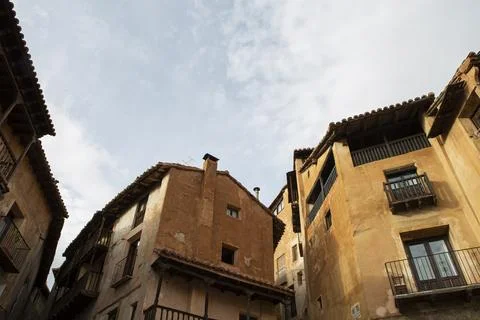 Typical orange-colored adobe and wood facades in the medieval village of Al.. Stock Photos