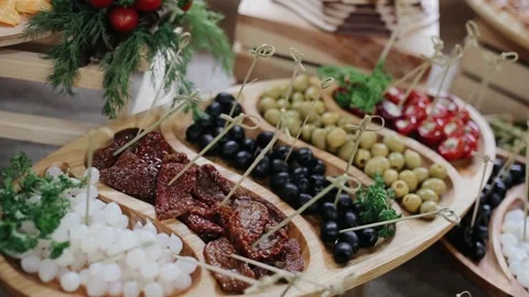 Typical plate served with different appetizer on the holiday buffet. Wooden Stock Footage 134612725