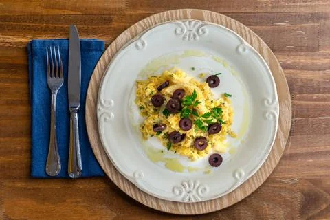 A typical Portuguese dish of shredded cod, with potato straw, mixed egg and d Stock Photos