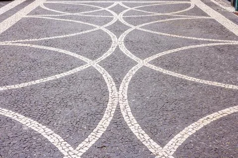 Typical Portuguese pavement with cobblestone patterns, hand-paved in Portug.. Stock Photos