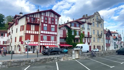 Typical red and white basque houses on the Quai Maurice Ravel in Ciboure, France Video stock 250538611