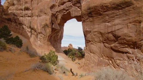 Typical red rock formations in Arches National Park with a huge hole in the rock Stock Footage 287725073