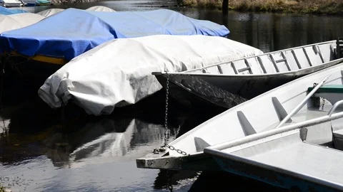 Typical river boats moored and covered with tarpaulins Stock Footage 87339084