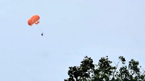 Typical scene showing a visitor enjoying a parasail ride at a resort in Stockbeeldmateriaal 333606857