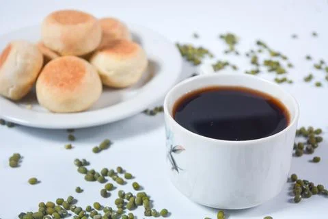 Typical snack from Java, Indonesia. Bakpia filled with nuts, black coffee a.. Stock Photos