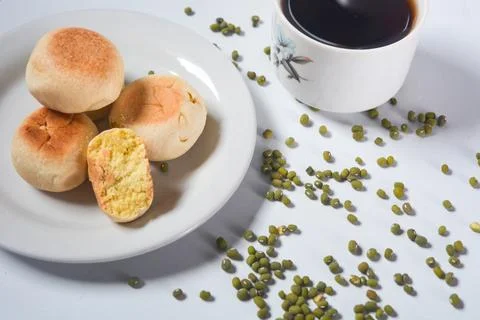 Typical snack from Java, Indonesia. Bakpia filled with nuts, black coffee a.. Stock Photos