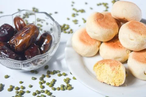 Typical snack from Java, Indonesia. Bakpia filled with nuts, black coffee a.. Stock Photos