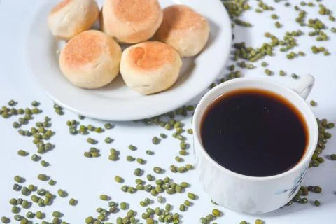 Typical snack from Java, Indonesia. Bakpia filled with nuts, black coffee a.. Stock Photos
