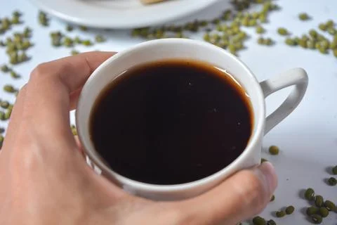 Typical snack from Java, Indonesia. Bakpia filled with nuts, black coffee a.. 스톡 사진