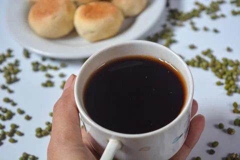 Typical snack from Java, Indonesia. Bakpia filled with nuts, black coffee a.. Stock-Fotos
