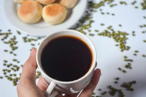 Typical snack from Java, Indonesia. Bakpia filled with nuts, black coffee a.. Stock Photos