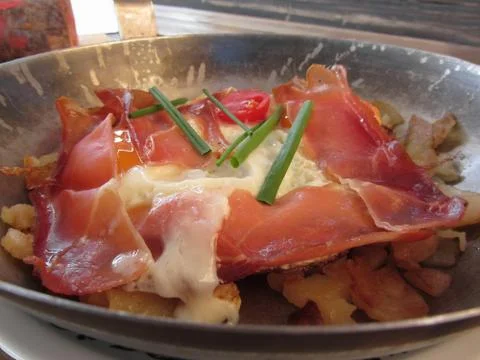 Typical South Tyrolean dish served pan fried with speck, mountain cheese eggs Stock Photos
