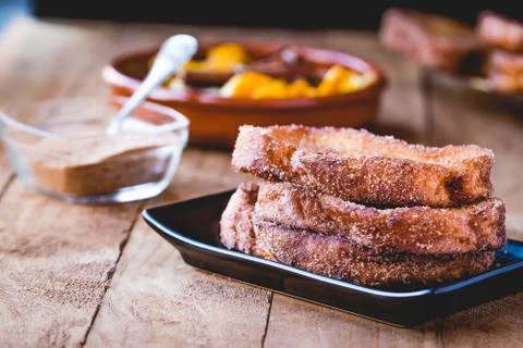 Typical Spanish food at the Easter festivities Torrijas whit sugar. Stock Photos