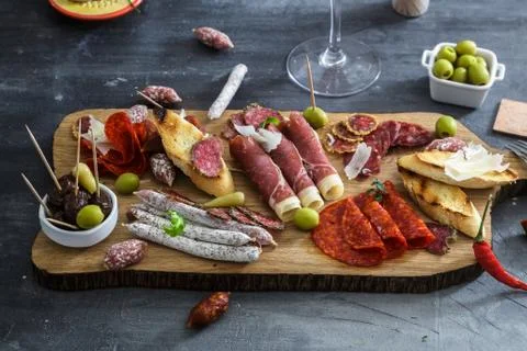 Typical spanish tapas concept. include variety slices jamon, chorizo, salami Stock Photos