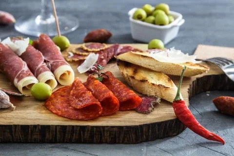 Typical spanish tapas concept. include variety slices jamon, chorizo, salami Stock Photos
