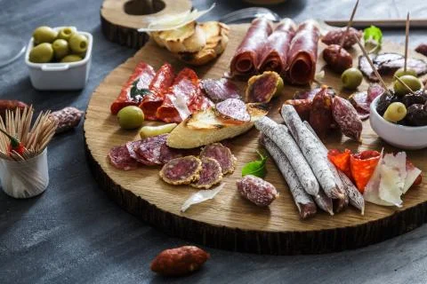 Typical spanish tapas concept. include variety slices jamon, chorizo, salami Stock Photos