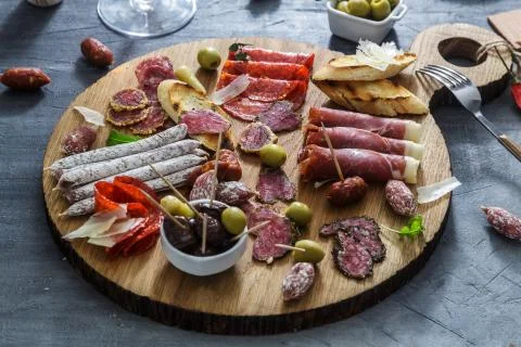 Typical spanish tapas concept. include variety slices jamon, chorizo, salami Stock Photos