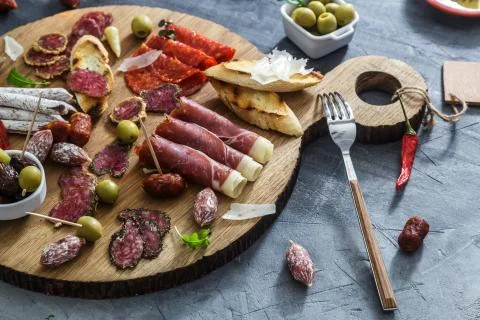 Typical spanish tapas concept. include variety slices jamon, chorizo, salami Stock Photos