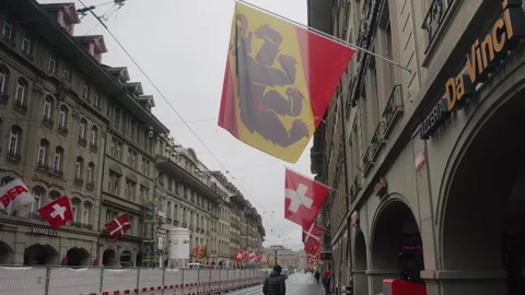 Typical street during the day in Bern Old town with Bern and Swiss flag waving Stock Footage 337588462