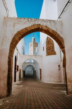 Typical street in the medina of Casablanca in Morocco. Mosque background. Col Stock Photos