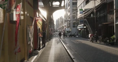 Typical street in Tokyo at sunset, wind blows advertising banners. People Stock Footage 140785222