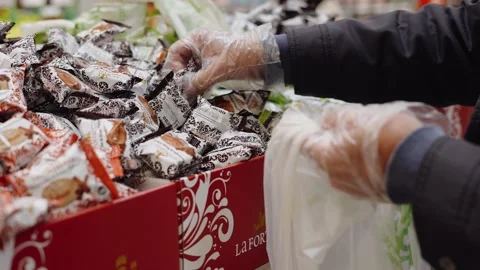 Typical sweets consumed at Christmas time in Spain. Man selecting some Stock Footage 164600697