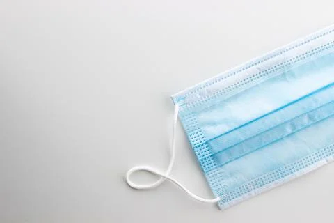 A typical three-layer surgical mask that covers the mouth and nose Stock Photos
