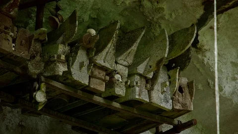 Typical Toraja tombs in a vertical rock face carved with traditional puppets Video stock 102590502
