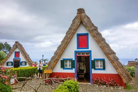 Typical triangular house, Madeira Santana, Portugal - June 7, 2013: Flower... Stock Photos
