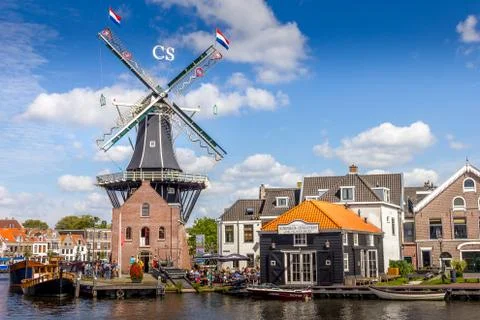 Typical windmill and medieval architecture in the port of Haarlem, Holland Stock Photos