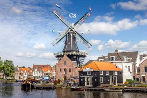 Typical windmill and medieval architecture in the port, Haarlem, The Netherlands Stock Photos