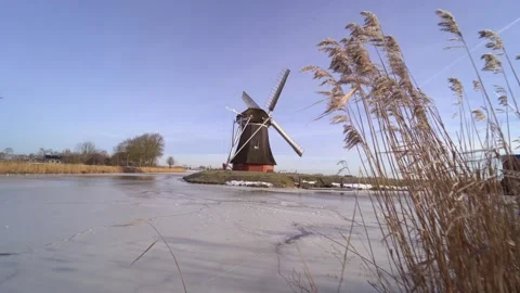 Typical winter dutch landscape with windmill.  Stock Footage 164928390