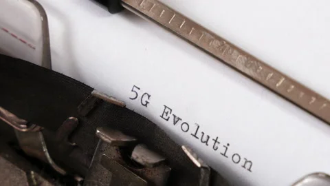 Typing 5G EVOLUTION  on an old typewriter. 4K Stock Footage 152038401