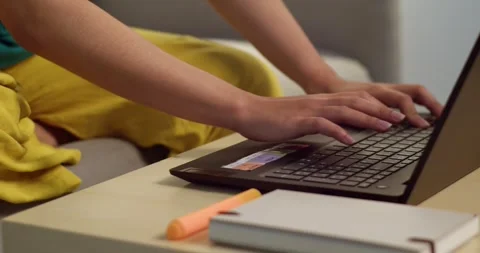Typing action by an individual at home office laptop usage in cozy environment Vídeos de archivo 336356897