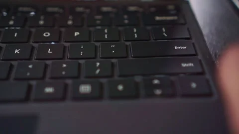 Typing action on a laptop keyboard on "Enter" button, ideal for digital Stock Footage 334748858