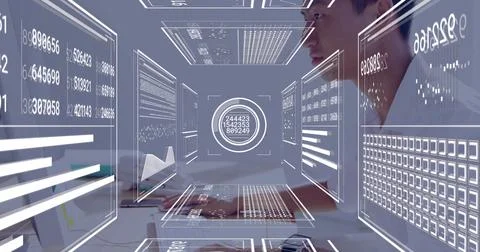 Typing Asian analyst processing holographic data panels at desk with keyboard 写真素材