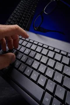 Typing away on computer keyboards Stock Photos