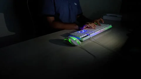 Typing on Backlit Keyboard in Dark Room, Person typing on a backlit keyboar.. Stock Footage 317736801