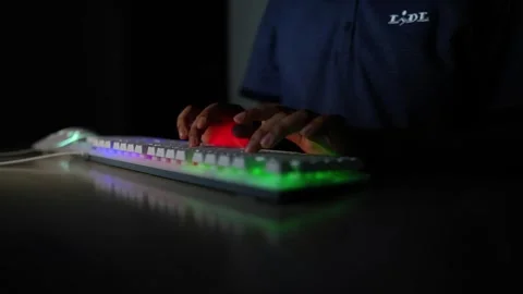 Typing on Backlit Keyboard in Dark Room, Person typing on a backlit keyboar.. Stock Footage 317736806