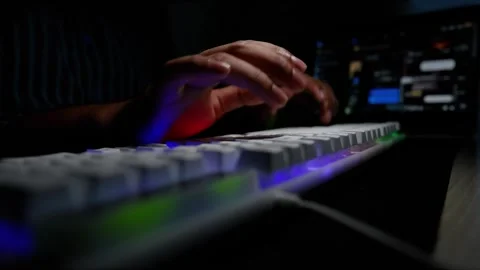 Typing on Backlit Keyboard in Dark Room, Hands typing on a backlit keyboard.. Stock Footage 317737384