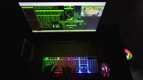 Typing on Backlit Keyboard with Security Footage Display Stock Footage 315982459