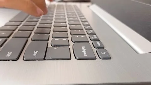 Typing on the black keyboard while working on the laptop Stock Footage 150398326