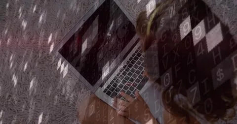 Typing child sitting on light gray shag rug, with glowing laptop keyboard, code Stock Photos