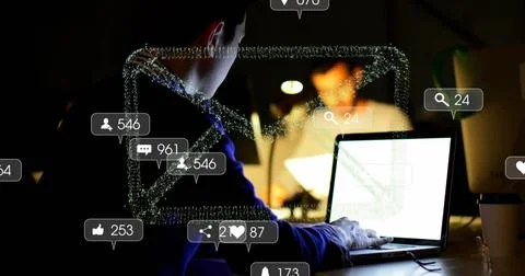Typing Chinese man using glowing laptop in dimly lit office room, with floating Stock Photos