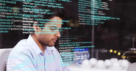 Typing code Asian man wearing blue shirt at office desk, with glass code refl Stock-Fotos