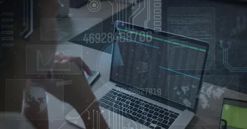 Typing coder wearing sleeved top at desk, laptop showing code, note, pen, green 스톡 사진