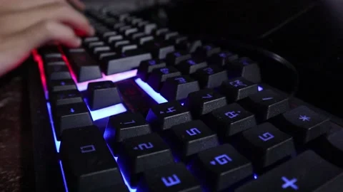 Typing on a colorfully glowing keyboard 库存影片 201816945