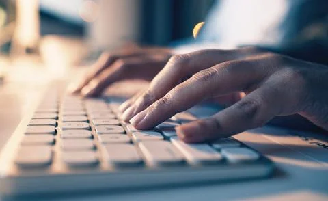 Typing, computer and night with hands of person in office for email, overtime Fotos Stock